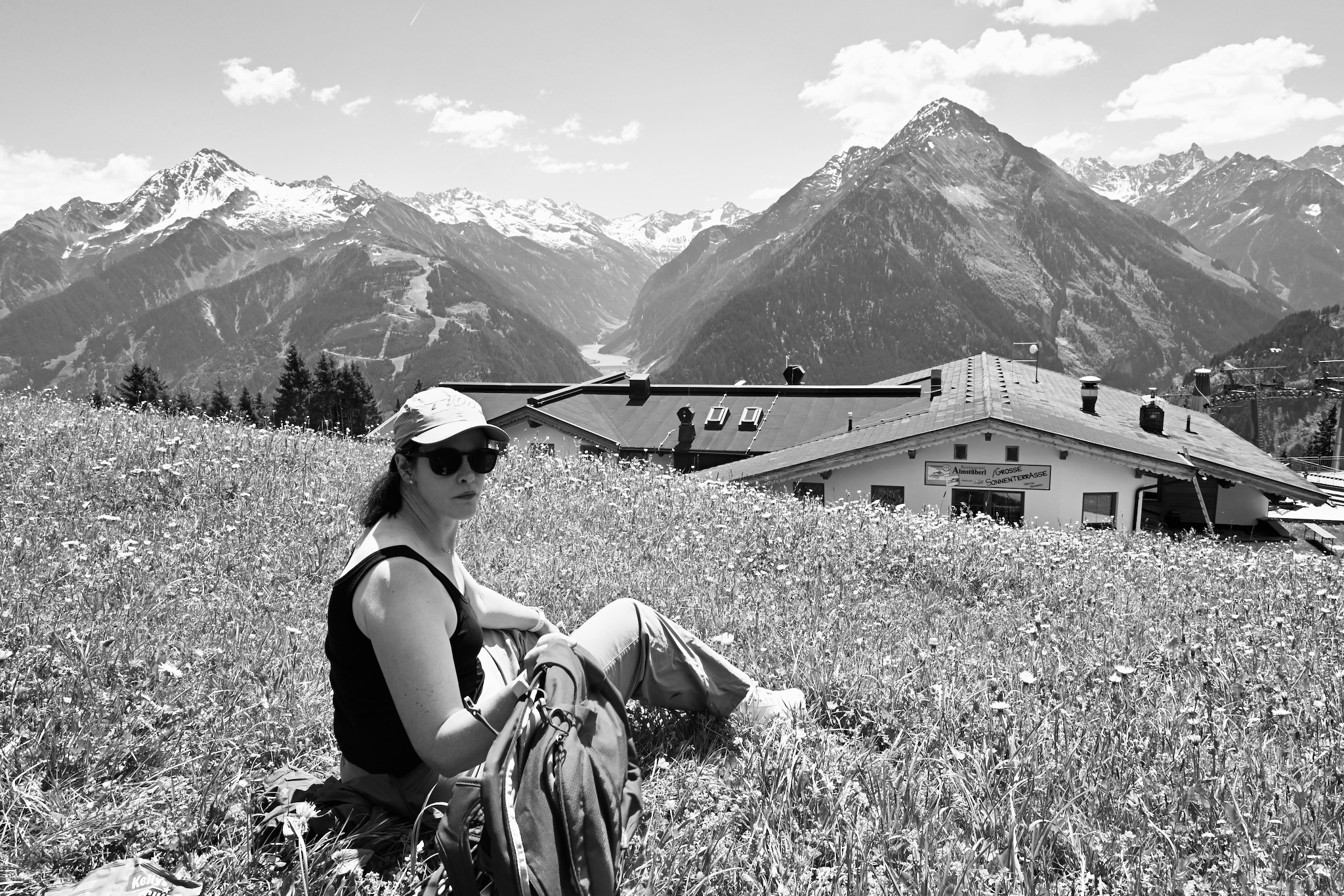 Caroline sitting in a wildflower meadow, black and white